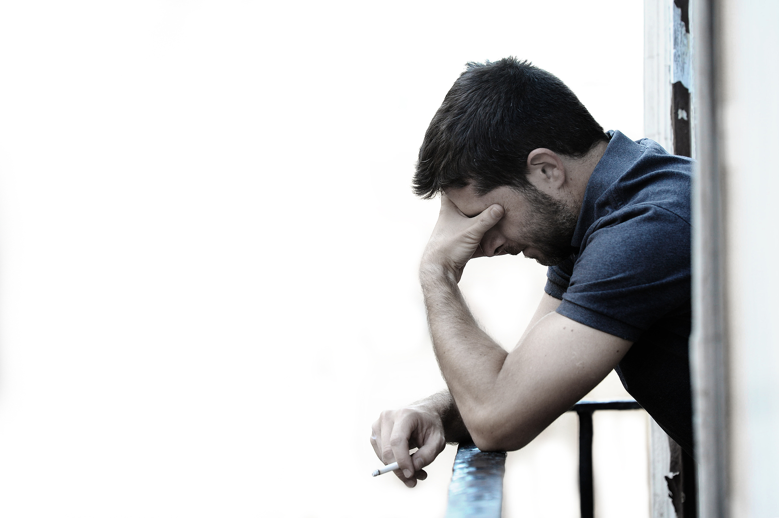 Young Man At Balcony In Depression Suffering Emotional Crisis An
