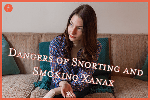 woman holding xanax pills that she can either snort or smoke
