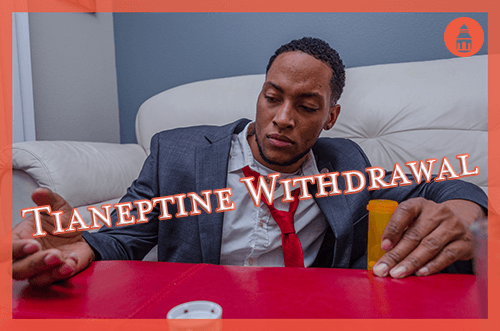 man sitting down staring at pills while in withdrawal from tianeptine