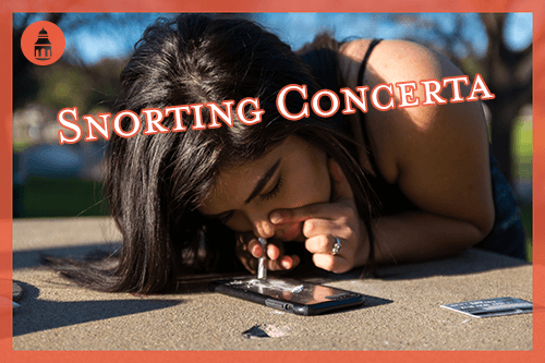 woman snorting concerta outside on a table